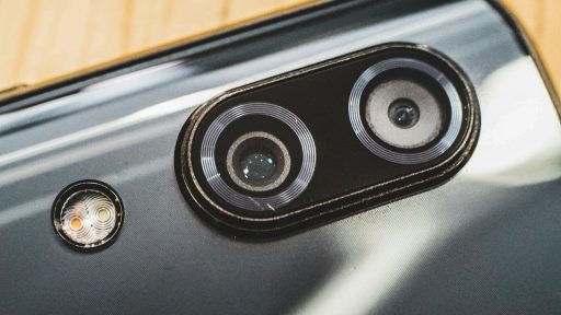 black and silver speaker on brown wooden table