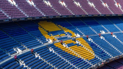 a sports arena with a field and seating