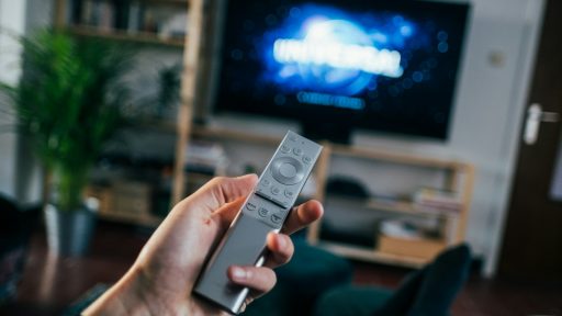 person holding gray remote control