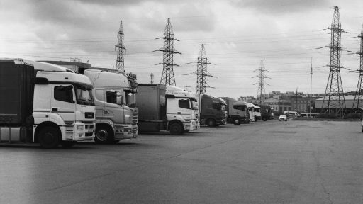 a black and white photo of trucks parked in a lot