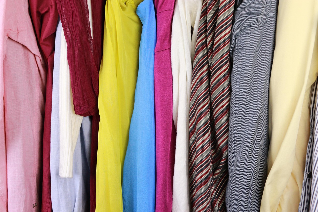 Man die kleding sorteert en zijn kast inruimt voor een capsulegarderobe