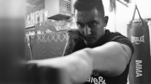 Man die traint op een bokszak in een sportschool