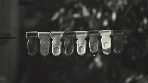 a line of scissors hanging from a clothes line