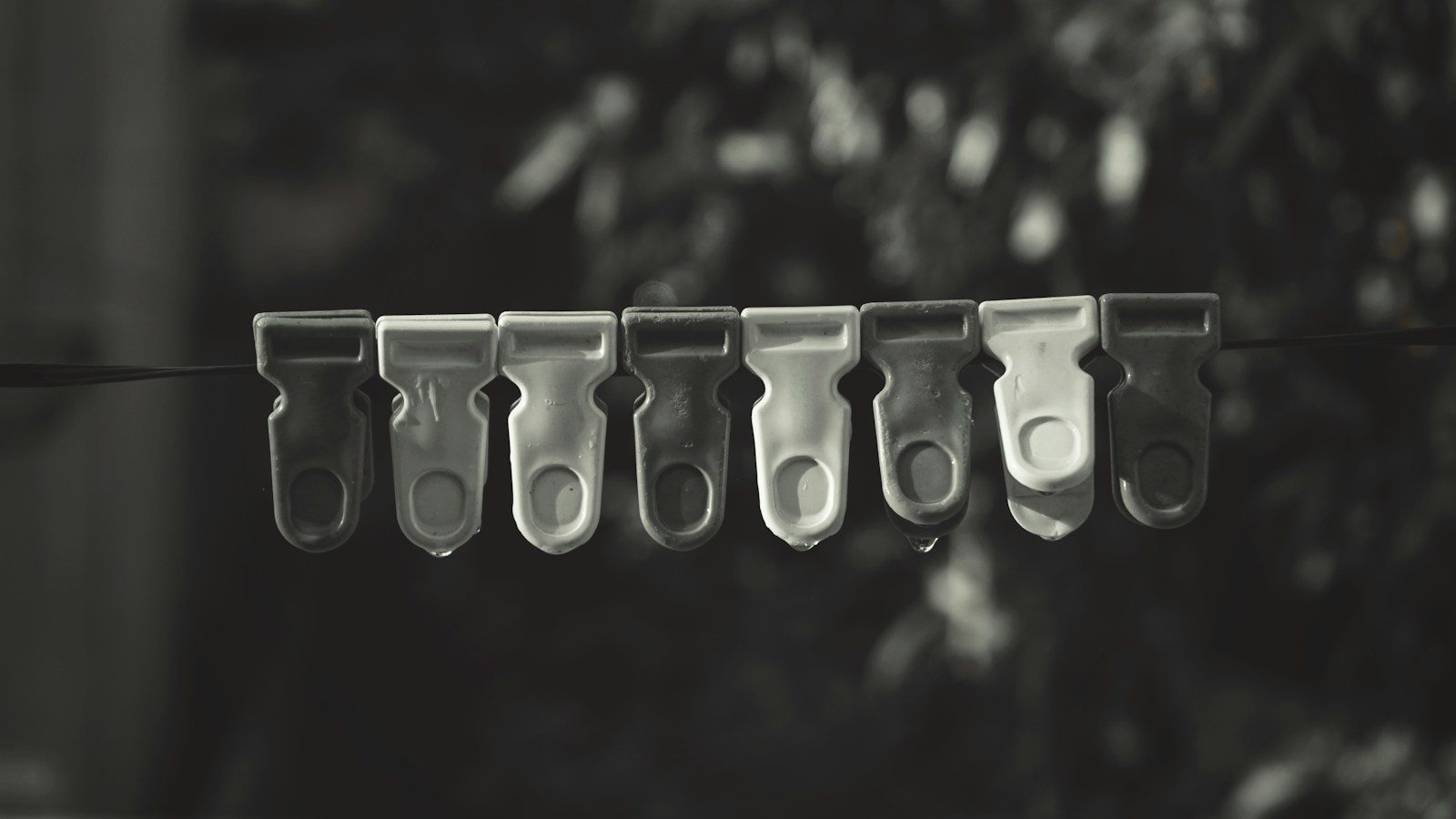 a line of scissors hanging from a clothes line