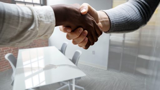 Man in gesprek aan bureau tijdens salarisonderhandeling op kantoor