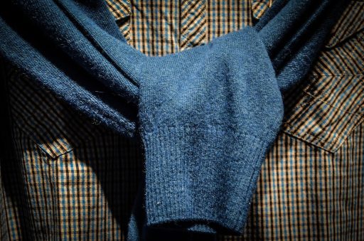 Man bekijkt overhemden in een kledingwinkel